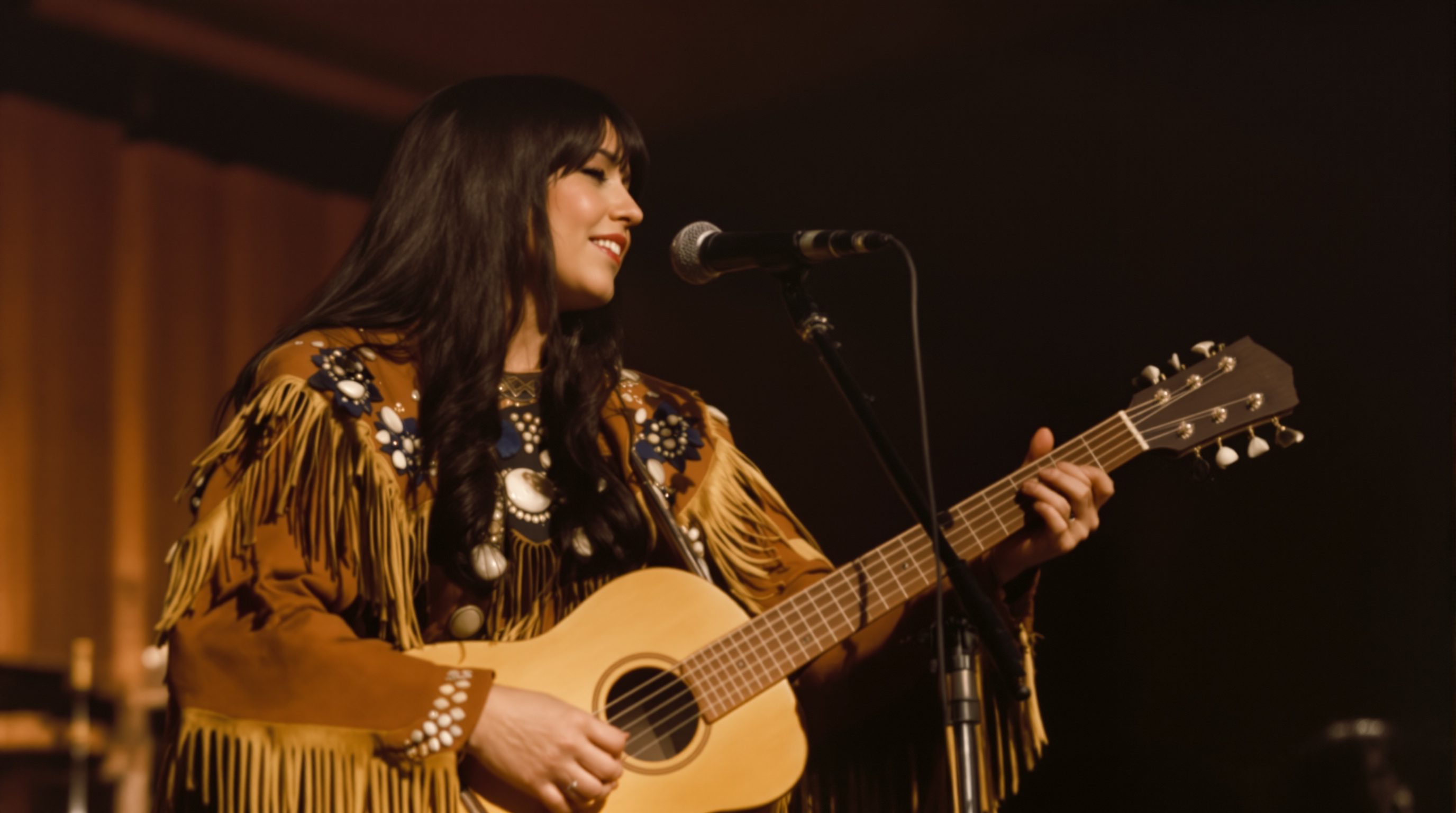 Buffy Sainte-Marie in a fringed jacket with shell decorations