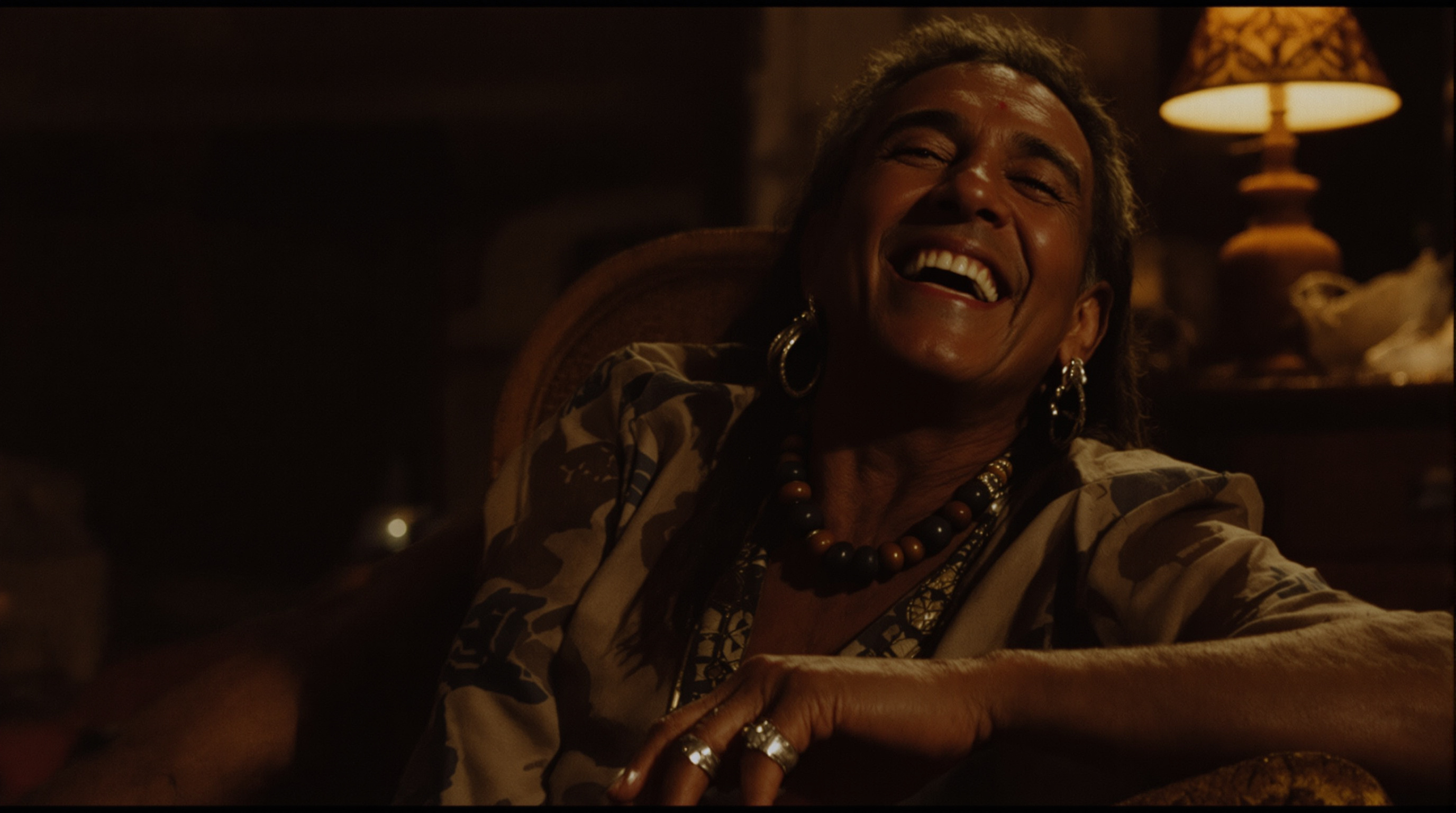 Buffy Sainte-Marie sitting and laughing, a candid photograph